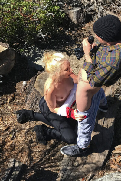 Blonde teen goes topless while sucking off a cock near a tree stump Image #5