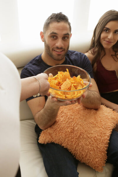 Sneaky slut gives a sly handjob on the couch while wife toils in the kitchen Image #5