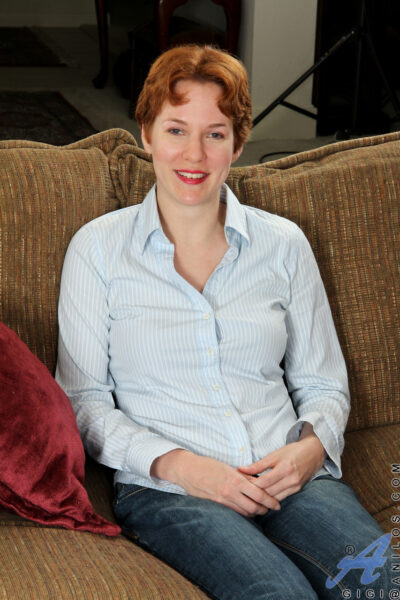 Short-haired ginger Gigi strips and masturbates while reading a book Image #1