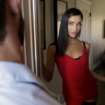 Alluring teen Emily Willis changes into a red dress to seduce an old flame