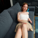 Redheaded teen Emma Korti exposes her natural boobs and meaty pussy in a solo