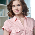 Teen babe Anne Teilor slowly takes off her pink blouse in the bed