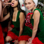 Teen girls take a selfie before a reverse gangbang with Santa Claus