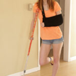 Injured redhead Pepper Hart pays for stepbro's help with doggystyle & creampie