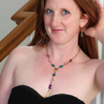 Natural redhead Aella Rae discards a black dress for her first nude session