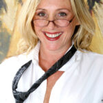 Mature blonde woman rolls off her hose to get at her moist pussy