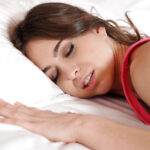 Petite coed Riley Reid posing solo in white thong panties on bed