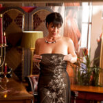 Wooing mature lady slipping off her glamorous clothes and caressing herself