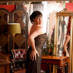 Wooing mature lady slipping off her glamorous clothes and caressing herself