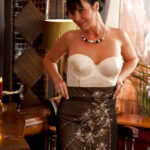 Wooing mature lady slipping off her glamorous clothes and caressing herself