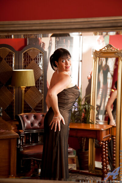 Wooing mature lady slipping off her glamorous clothes and caressing herself Image #1